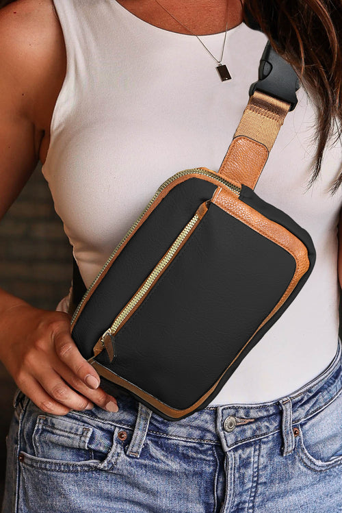 Girl  wearing a black and brown crossbody bag over a white sleeveless top and jeans 