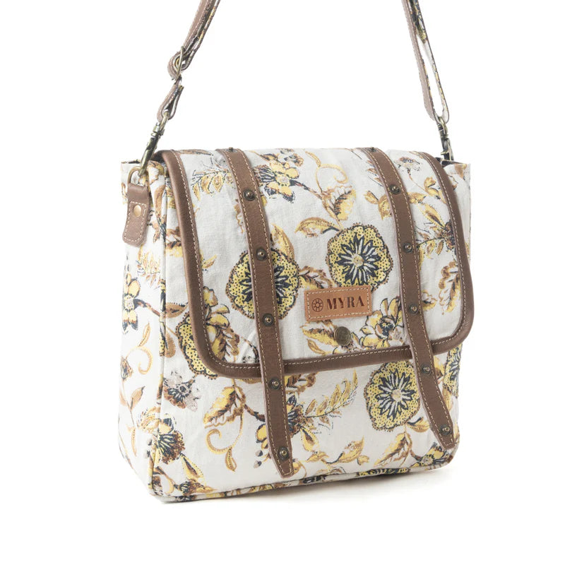 Floral patterned Myra Messenger handbag with brown accents on a white background