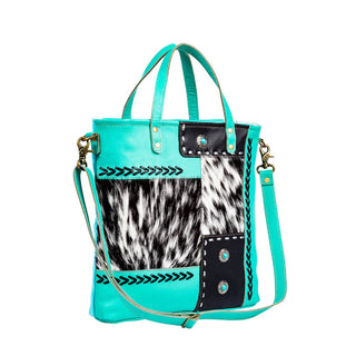 Myra turquoise handbag with cowhide pattern and decorative elements. 