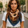 Woman wearing a leopard and buckle print stylish scarf with a blurred street background